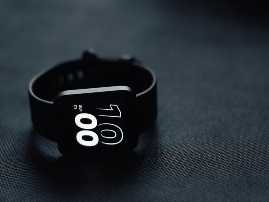 Smartwatch resting on a dark fabric surface